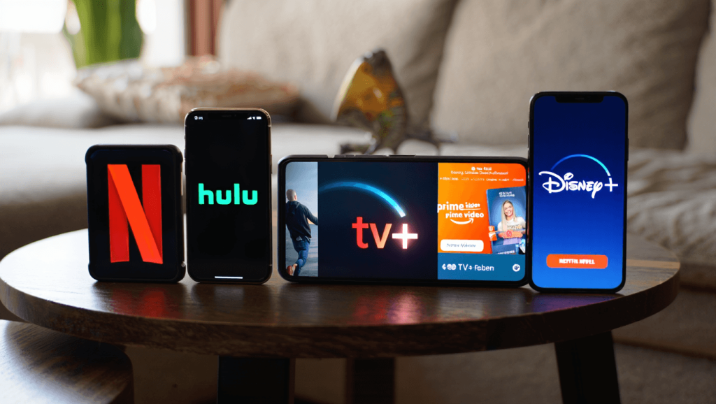 Comparatif des meilleurs services de streaming : Netflix, Hulu, Apple TV+, Prime Video et autres Netflix, Disney Plus and Amazon Prime Video running on TV screens for our best streaming services 2022 article.