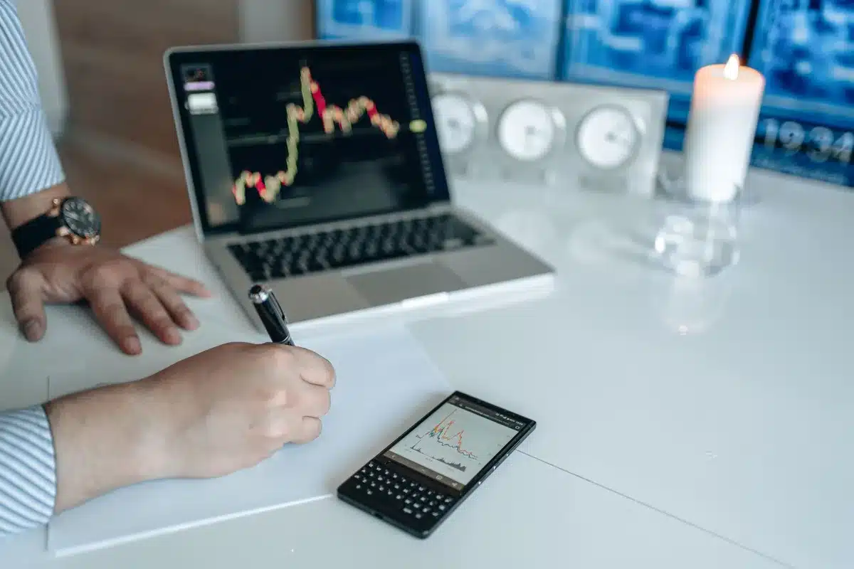 close-up of anonymous hands on a keyboard, screen showing an unbranded analytics dashboard with falling line, no identifiable person